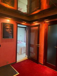 a room with doors leading to a bedroom with a bed at Aiavilja Red Pearl Apartment in Paide