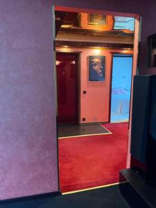 a room with a red carpet and a mirror at Aiavilja Red Pearl Apartment in Paide