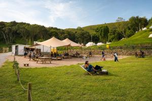 a group of people sitting in chairs in a field at Kampaoh Las Arenas in Pechón