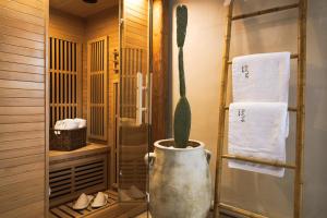 a cactus in a large vase in a bathroom at Diastar Boutique in Heraklio