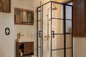 a bathroom with a shower with a glass door at Diastar Boutique in Heraklio