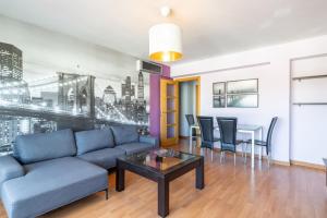a living room with a couch and a table at Apartamento familiar acogedor in Ordes