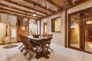 a dining room with a wooden table and chairs at Diastar Boutique in Heraklio +37 photos