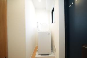 a white appliance sitting on a table in a room at Hotel Otsukahouse in Tokyo