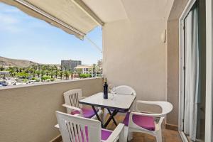 a table and chairs on a balcony with a view at Los Cristianos Plaza Centre suite in Los Cristianos