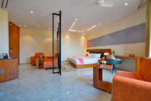 a hotel room with a bed and a desk at Ginger Gadchiroli in Garhchiroli
