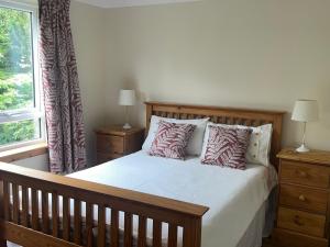 a bedroom with a bed with pillows and a window at Asgard in Big Sand +12 photos