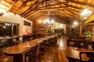 a large dining room with wooden tables and chairs at Urvinkaan - An Estate Hotel Chikmagalur in Chikmagalur +32 photos