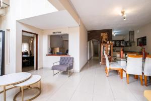 a kitchen and living room with a table and chairs at Siyajabula Guesthouse in Howick
