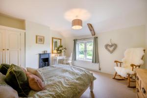 a bedroom with a bed and a desk and a window at 2 Bed in Upton oc-867 in Upton