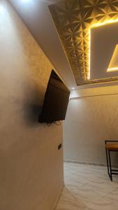 a ceiling with a tv in a room at Lux New Apartment in Mrhila