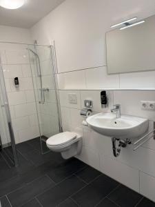 a bathroom with a toilet and a sink and a shower at Ephesus am Weserwehr in Drakenburg +23 photos