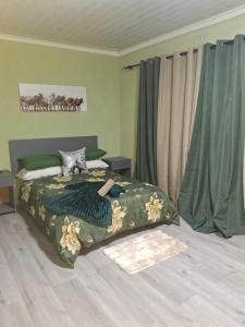 a woman laying on a bed in a bedroom at Jacaranda Bnb in Khayelitsha