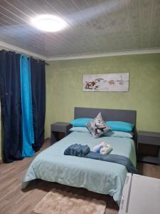 a bedroom with two beds with blue pillows at Jacaranda Bnb in Khayelitsha