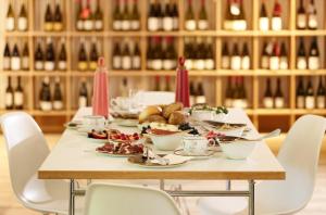 a table with food on it with chairs and wine bottles at Herrenhaus - Weingut Freiherr v. Landenberg in Ediger-Eller