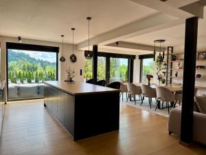 a kitchen and dining room with a table and chairs at Willa Black Wood in Istebna