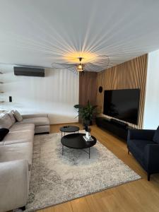a living room with a couch and a table at Willa Black Wood in Istebna