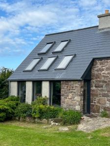 a house with a roof with the word fix on it at Asgard in Big Sand