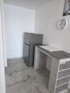 a kitchen with a counter and a refrigerator at Amfora apartament Studio in Lezhë