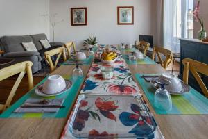 a long table with plates of food on it in a living room at Demeure Olea, Chambres D'hôtes in Chérac +21 photos