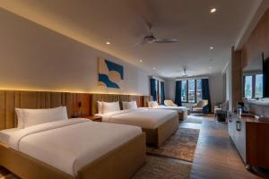 a hotel room with two beds and a living room at IFQ Premier Skardu in Skardu