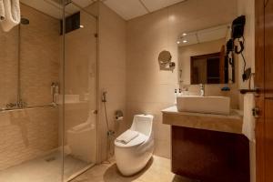 a bathroom with a toilet and a sink and a shower at IFQ Premier Skardu in Skardu +39 photos
