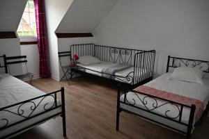 a room with two beds and a window at Cottage des Moutons Espiègles in Saint-Martin-de-Nigelles +30 photos