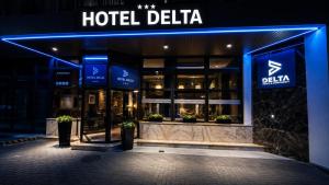 a hotel delia building at night with blue lights at Hotel Delta in Krakow