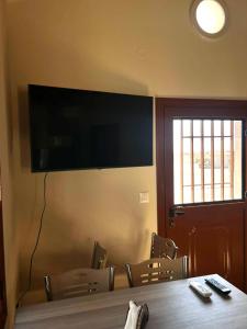 a conference room with a table and chairs and a flat screen tv at Limanaki 1 in Chios +2 photos