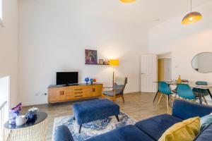a living room with a blue couch and a table at 1 Bed in Cromer oc-1844 in Cromer