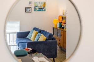 a living room with a blue couch and a mirror at 1 Bed in Cromer oc-1844 in Cromer