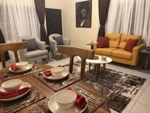a living room with a table and a couch at ChallawaRiver Homes in Calabar +36 photos