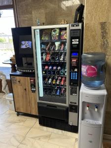 a vending machine filled with lots of drinks at Hotel Artimino in Timişoara