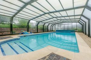 an indoor swimming pool with a glass ceiling at 5 Bed in Magham Down oc-sx942 in Hailsham
