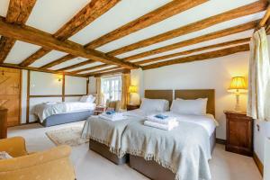 a bedroom with two beds in a room with wooden ceilings at 5 Bed in Magham Down oc-sx942 in Hailsham +41 photos