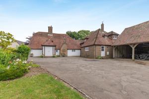 a group of old brick houses with a driveway at 5 Bed in Magham Down oc-sx942 in Hailsham