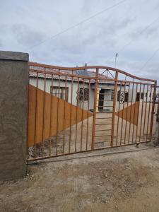 a metal gate in front of a building at Mams Cozy Guest house in Seshego
