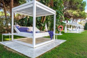 a white gazebo with a bed in the grass at Estival Isla Cristina in Isla Cristina +46 photos