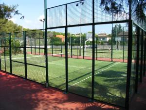 a tennis court with a net on a court at Camping Estival Torre de la Mora in Tamarit