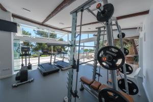 a gym with cardio equipment in a house at Camping Estival Torre de la Mora in Tamarit +164 photos