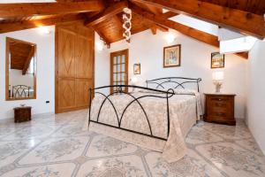 a bedroom with a bed in a room with wooden ceilings at Luna Rossa in Minori