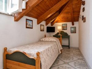 a bedroom with a bed and a television in a room at Luna Rossa in Minori +11 photos