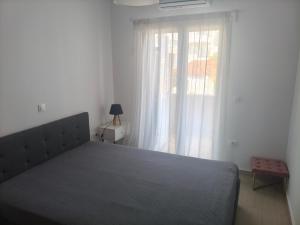 a bedroom with a large bed and a window at Oikonomou Villas 2 in Ermioni