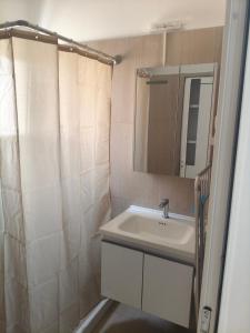 a bathroom with a sink and a mirror at Oikonomou Villas 2 in Ermioni +22 photos