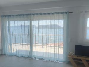 a room with a window with a view of the beach at Oikonomou Villas 2 in Ermioni