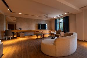 a living room with a couch and a table and chairs at IFQ Premier Skardu in Skardu