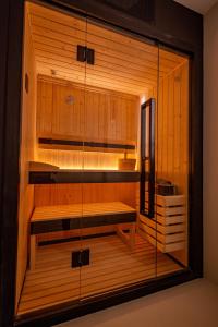 a sauna with wooden walls and benches in a room at Marea Boutique Hotel in Orosei