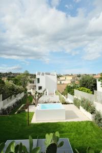 a view of the backyard of a house with a swimming pool at Marea Boutique Hotel in Orosei