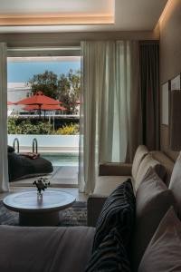a living room with a couch and a table at Santorini Heart Hotel & Spa in Fira