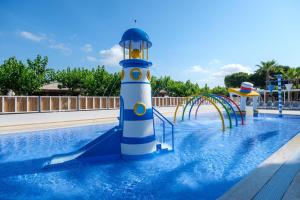 a blue and white lighthouse in the middle of a pool at Camping Estival Vendrell Platja in Comarruga +64 photos